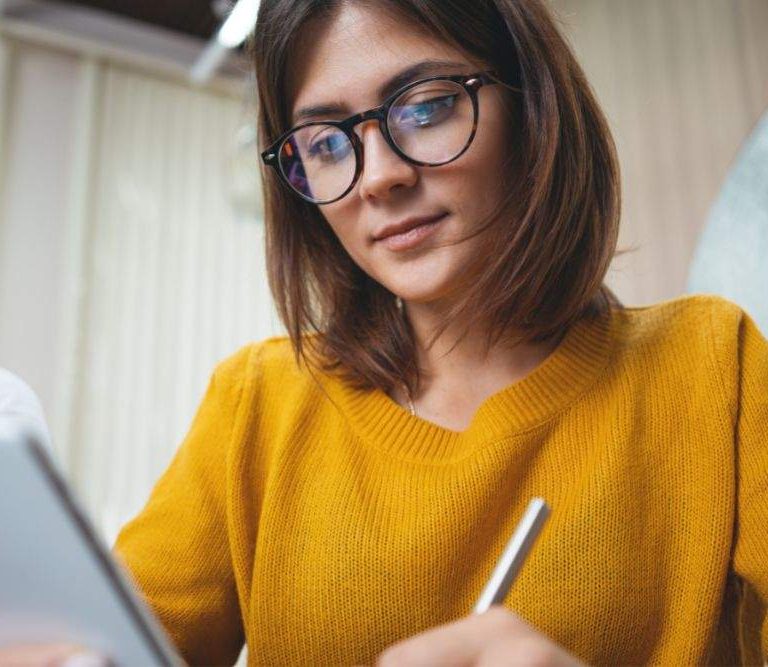 mulher utiliza a comunicação no trabalho de forma híbrida